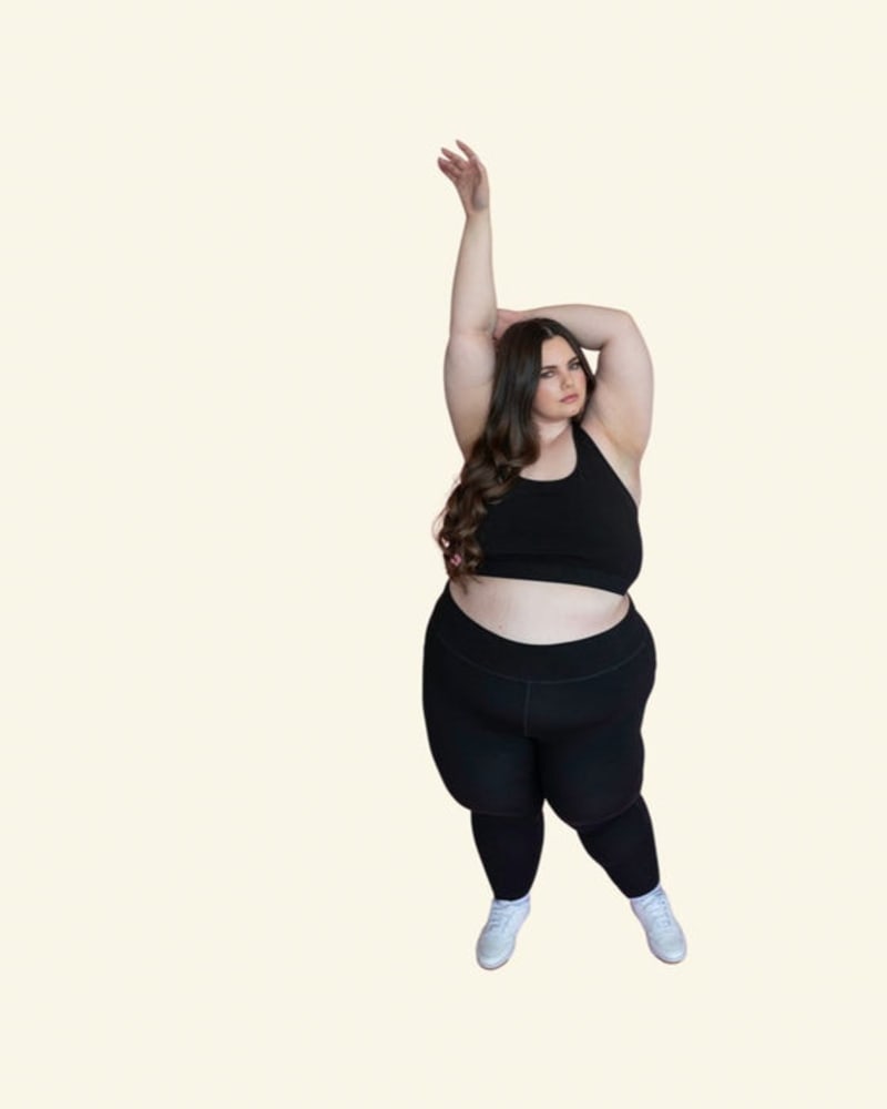 Front of a model wearing a size 10 Sage Sports Bra in Black by Reprise Activewear. | dia_product_style_image_id:254077